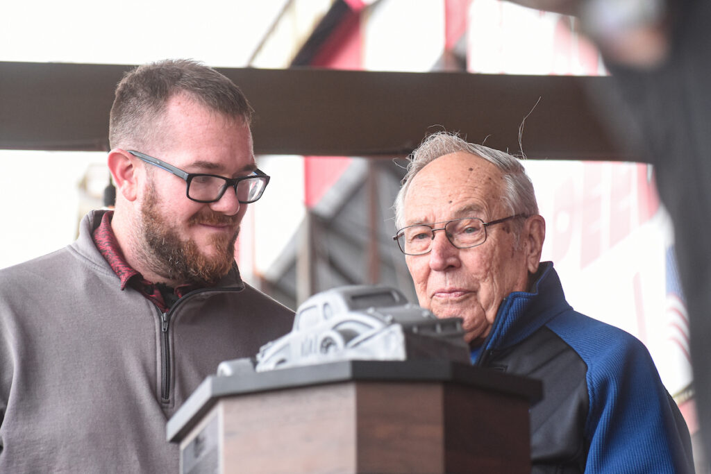 Mike Warren and Buzzie Reutimann look at trophy
