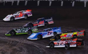 Group of Late Models race out of Turn 2 at Tri-State Speedway