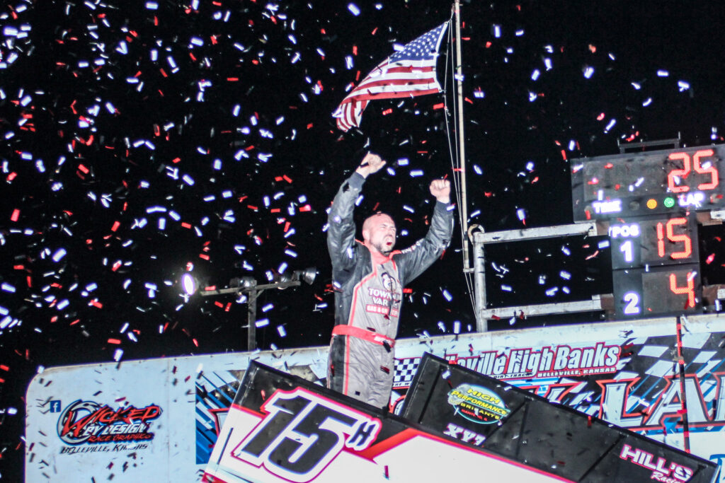 American Sprint Car Series driver Sam Hafertepe celebrating atop his Sprint Car in Belleville High Banks Victory Lane