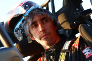 Zach Daum sitting in his Midget race car at an Xtreme Outlaw Midget Series event