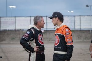 Colorado natives Bryan and Austyn Gossel standing in the pit area at an American Sprint Car Series event having a conversation