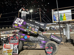 Sprint Car driver Seth Bergman celebrating atop his car in Electric City Speedway Victory Lane after winning an American Sprint Car Series event