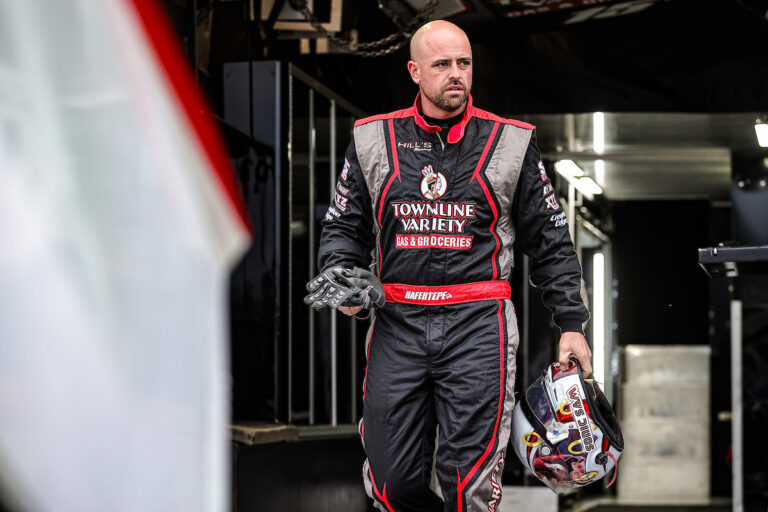 Sam Hafertepe Jr. walking next to his car at an American Sprint Car Series event