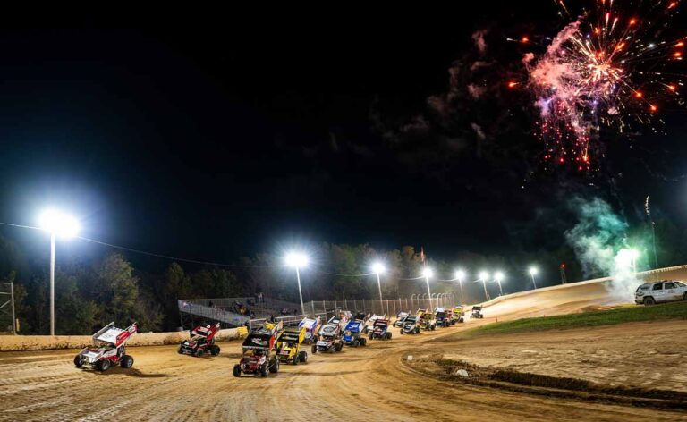 Sprint Cars on track as fireworks fly behind them