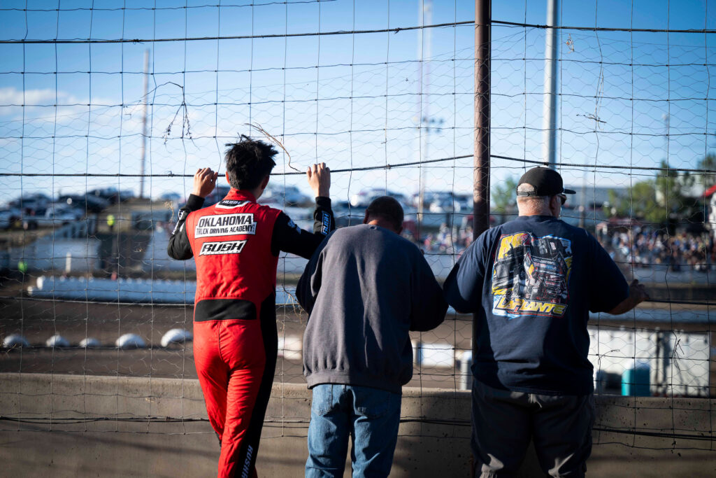 Driver and crew looking over the track