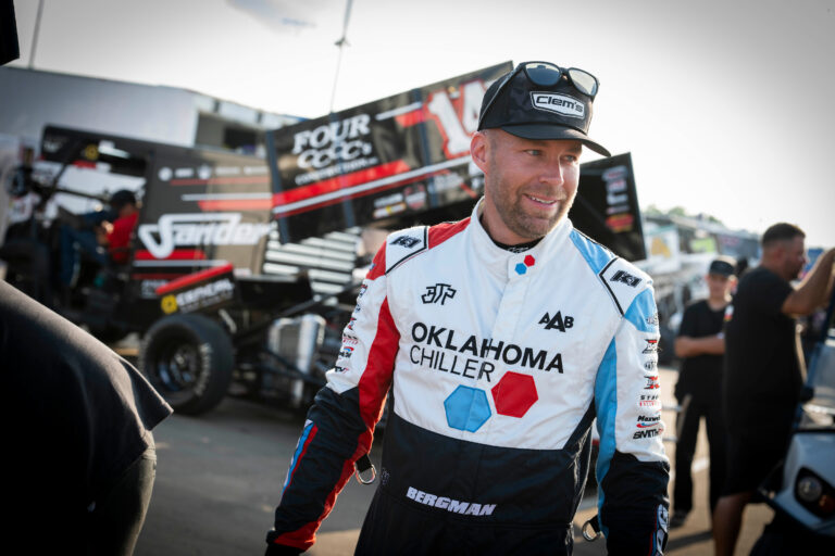 Seth Bergman smiling while walking in pits