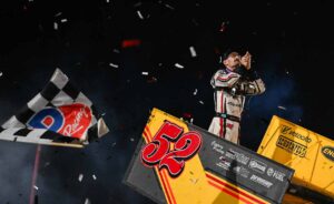 Blake Hahn celebrates atop his car as the checkered flag falls