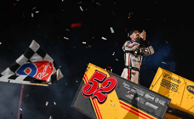 Blake Hahn celebrates atop his car as the checkered flag falls